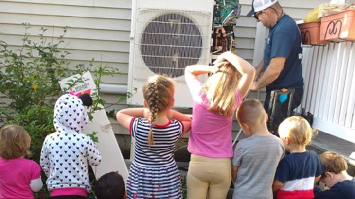 Children watching technician