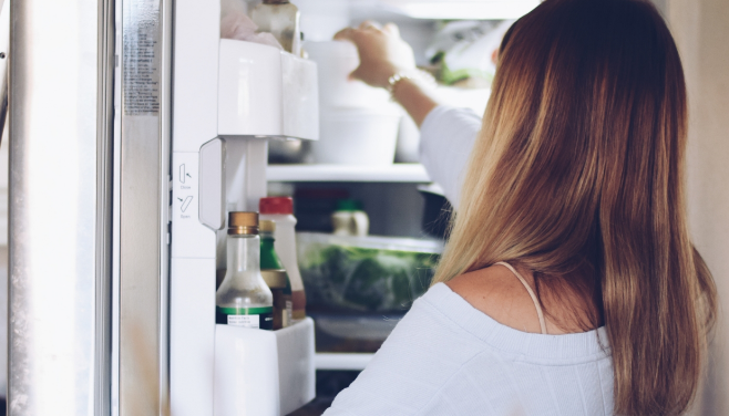 Women looking inside a refrigerator